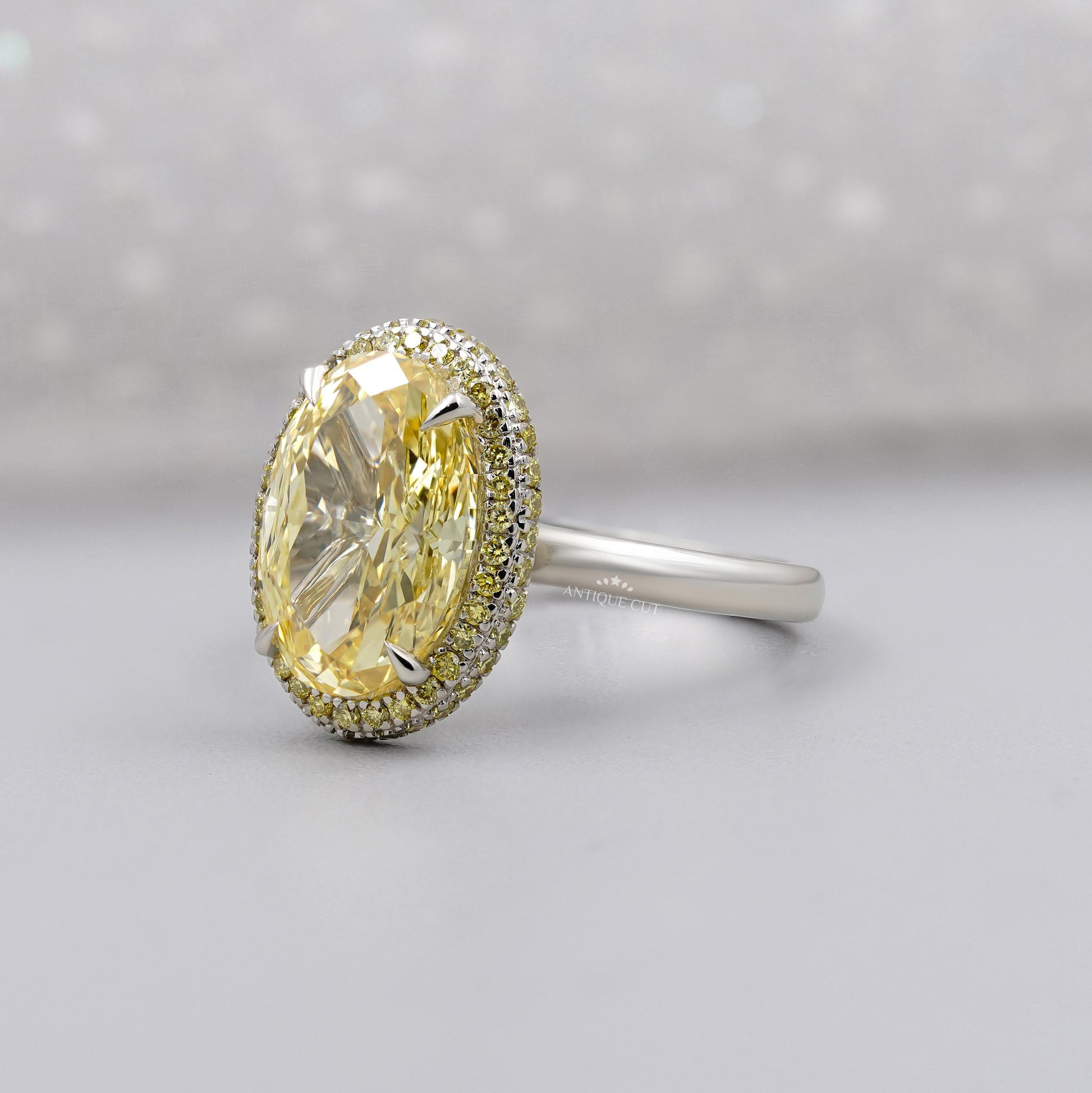 Oval cut fancy yellow diamond double halo engagement ring