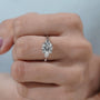 Minimalist engagement ring design with cushion cut diamond and baguette accents in white gold.