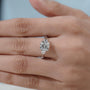 Elegant white gold engagement ring with cushion cut diamond center and IGI certified stones.