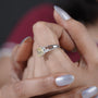 Proposal ring with cushion cut diamond and side stones