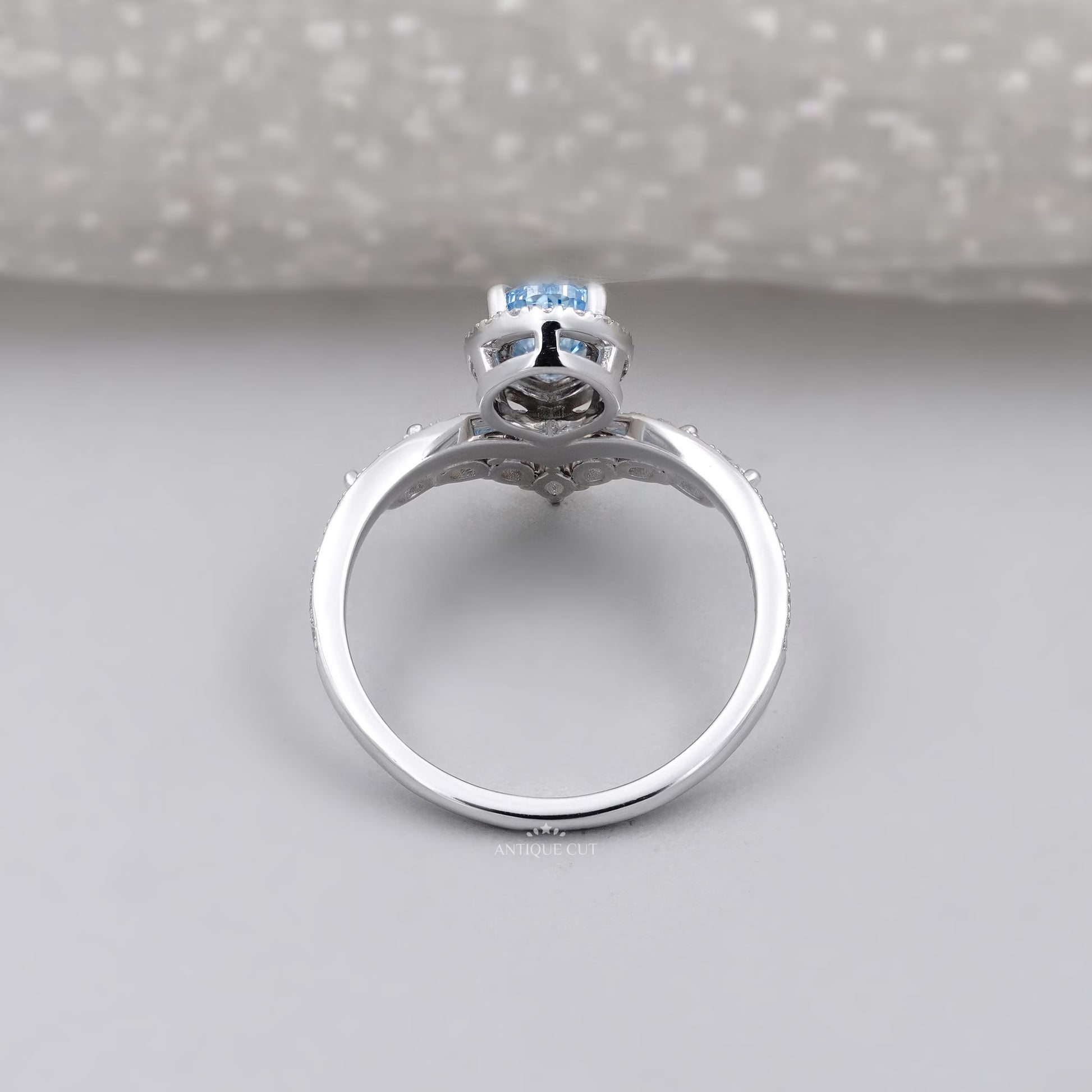 Fancy blue pear cut diamond halo engagement ring with wedding band