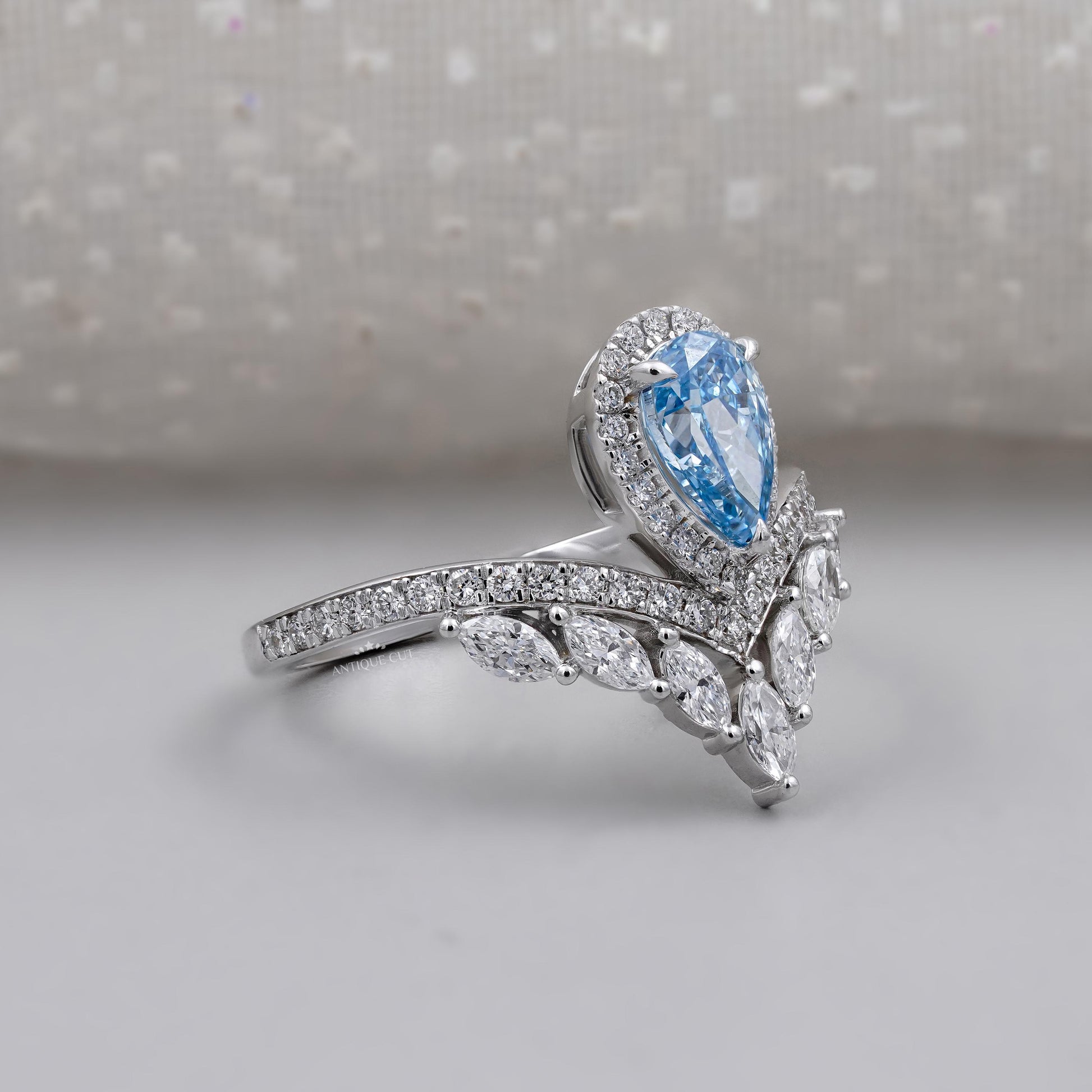 Fancy blue pear diamond engagement ring with halo