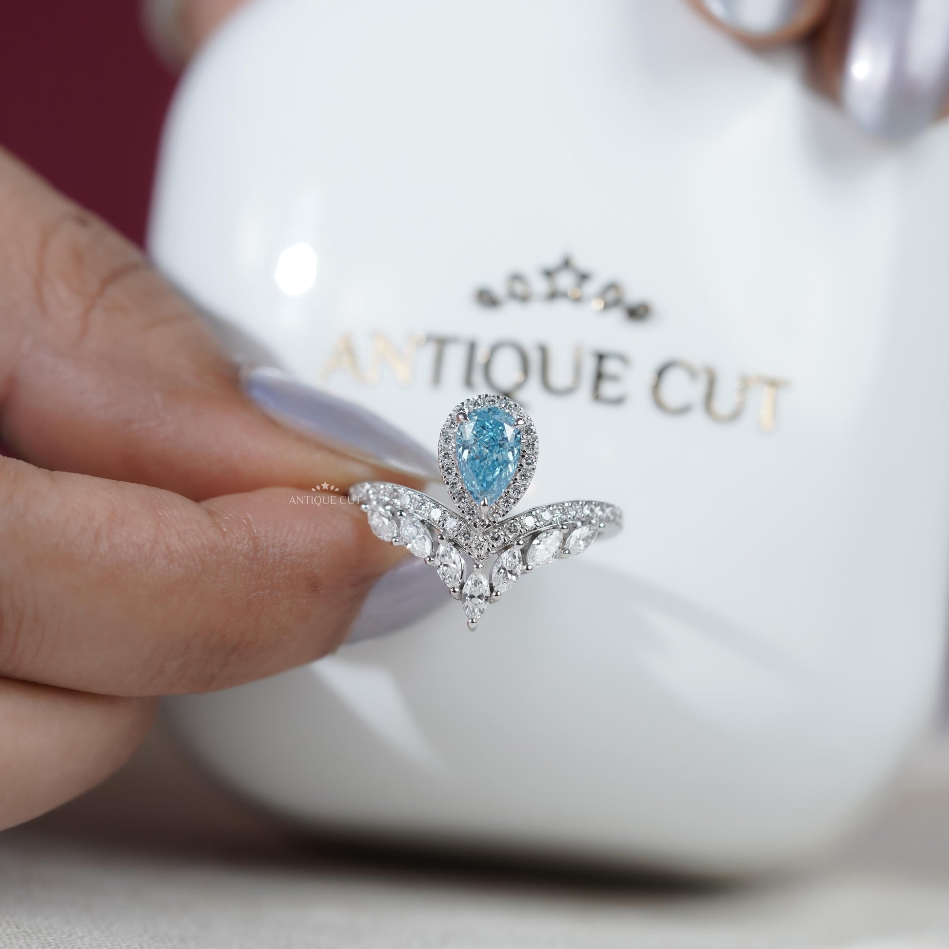 Elegant bridal pear cut blue diamond halo ring