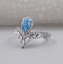 Lab grown pear cut blue diamond halo ring design