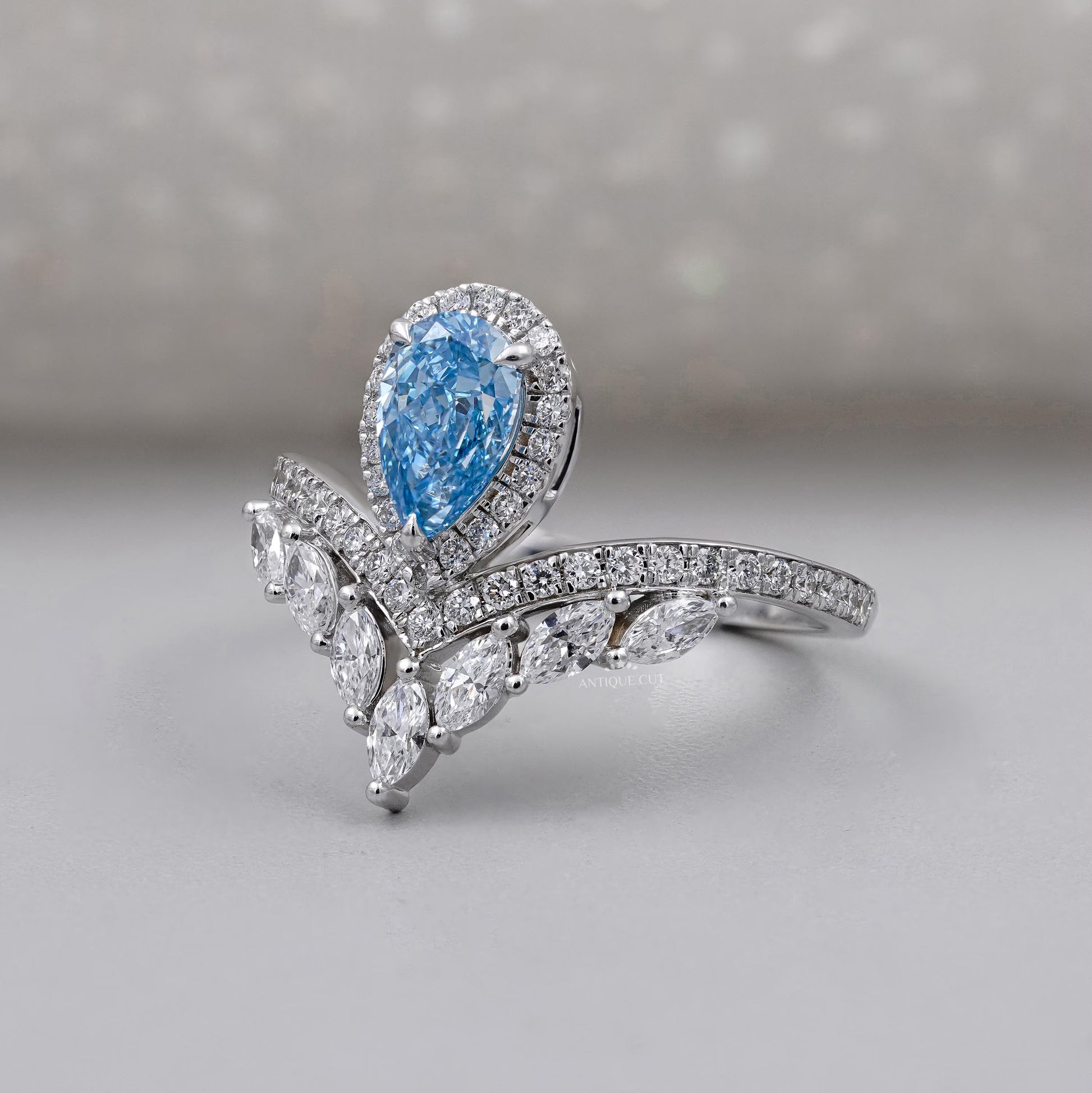 Lab grown pear cut blue diamond halo ring design