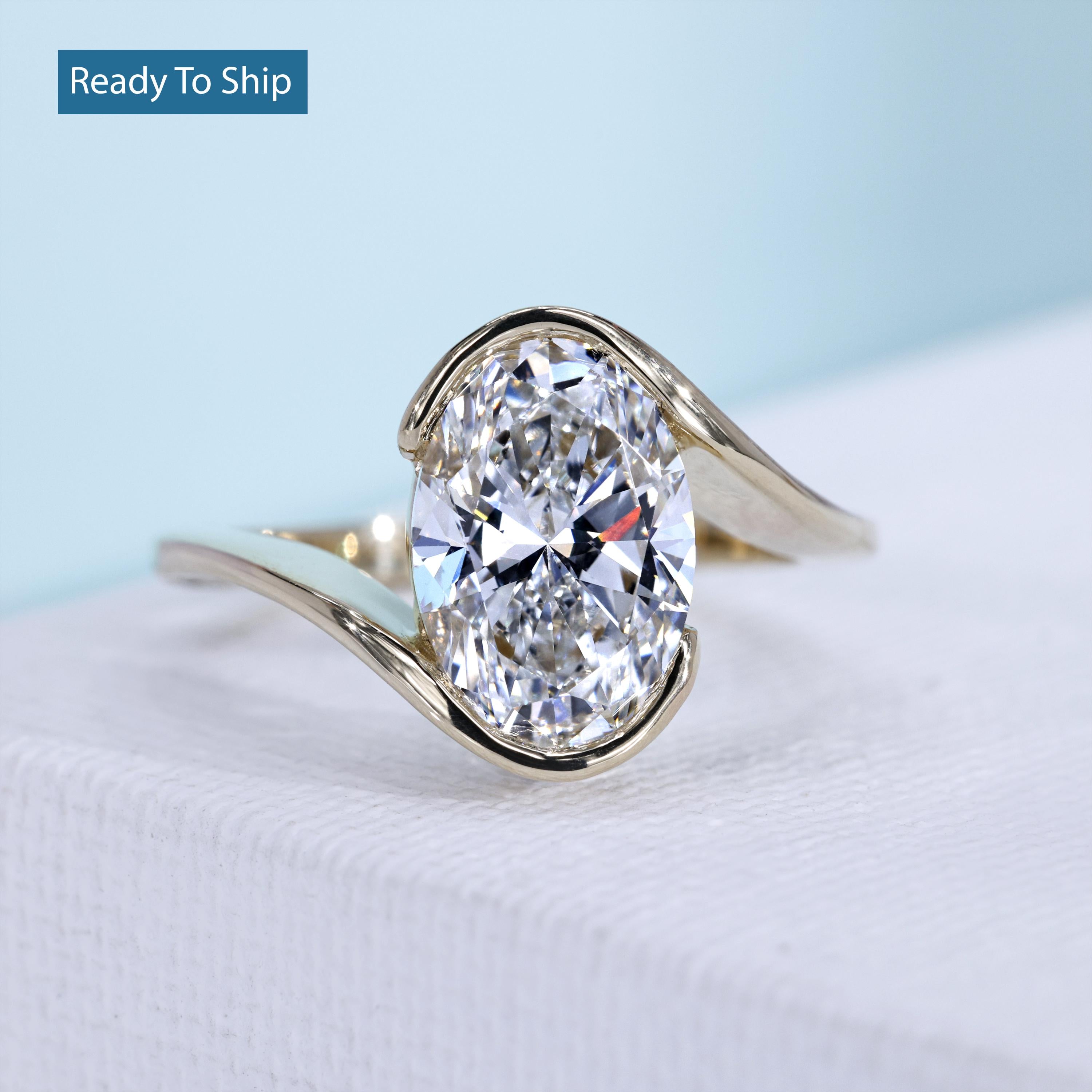 Modern oval lab grown diamond bypass ring yellow gold