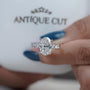 Classic oval diamond engagement ring with white gold pavé band