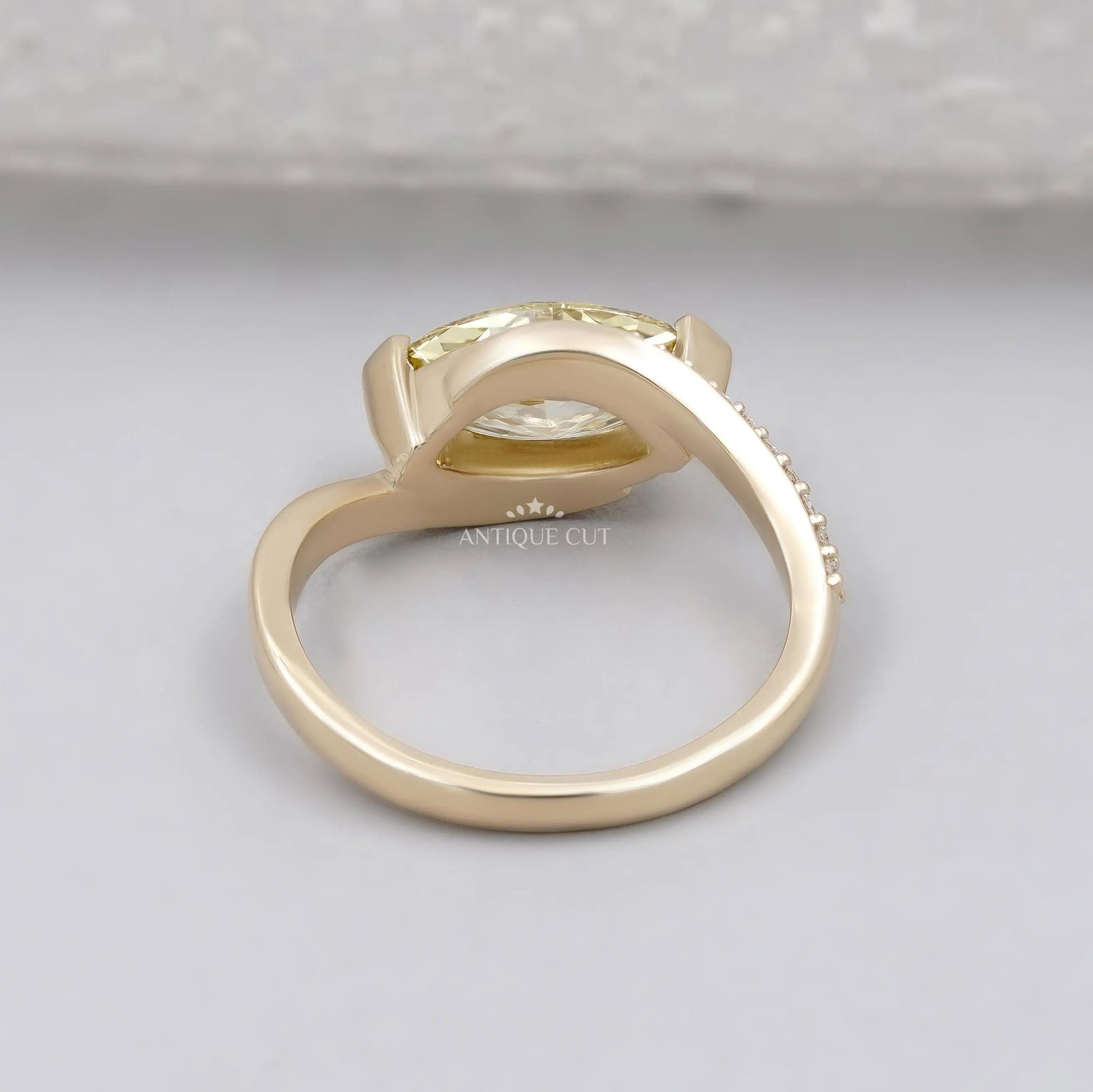 Marquise yellow diamond ring with round side stones
