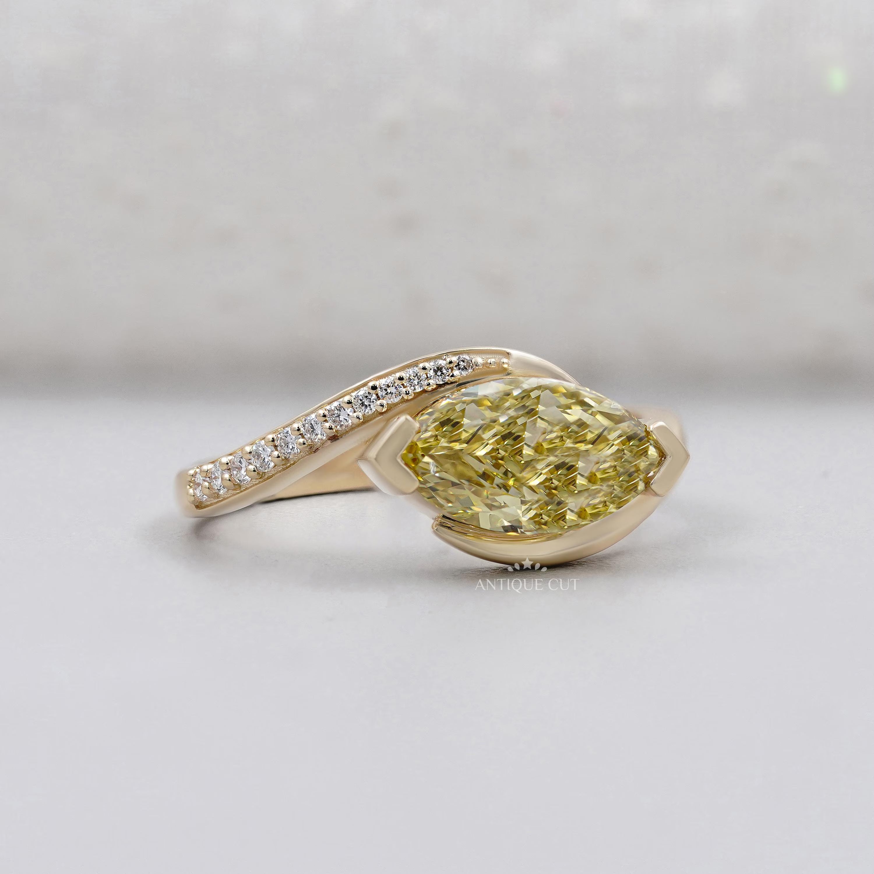 Fancy yellow marquise diamond engagement ring with bypass band