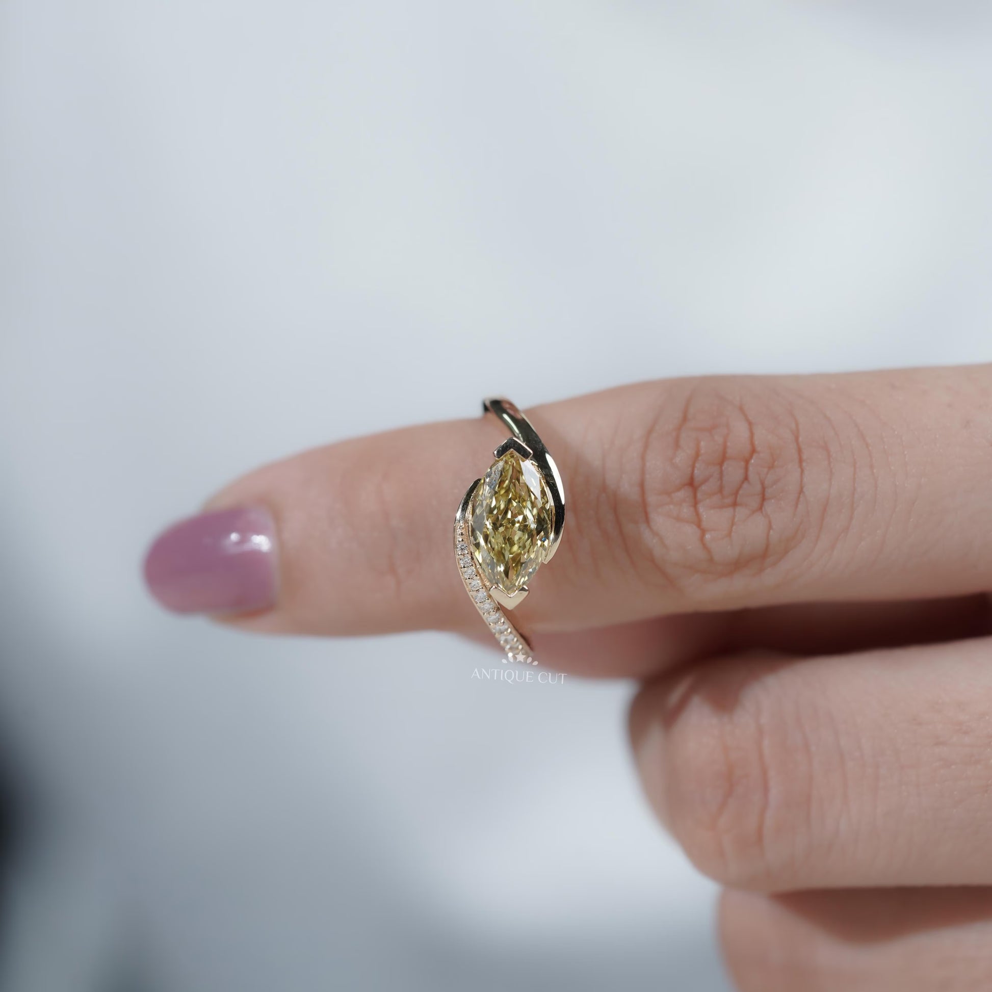 Yellow diamond engagement ring with round side stones