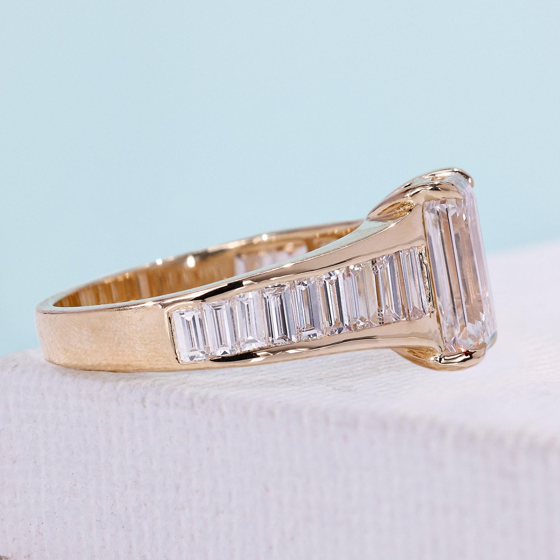 Emerald cut diamond ring with side stones
