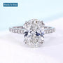 Oval diamond hidden halo engagement ring with white gold cathedral setting