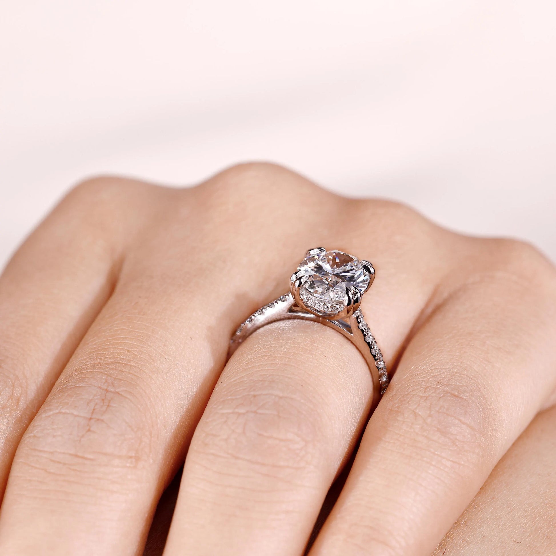 Cathedral setting oval diamond ring with hidden halo accents