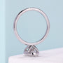 White gold bezel engagement ring with oval center diamond