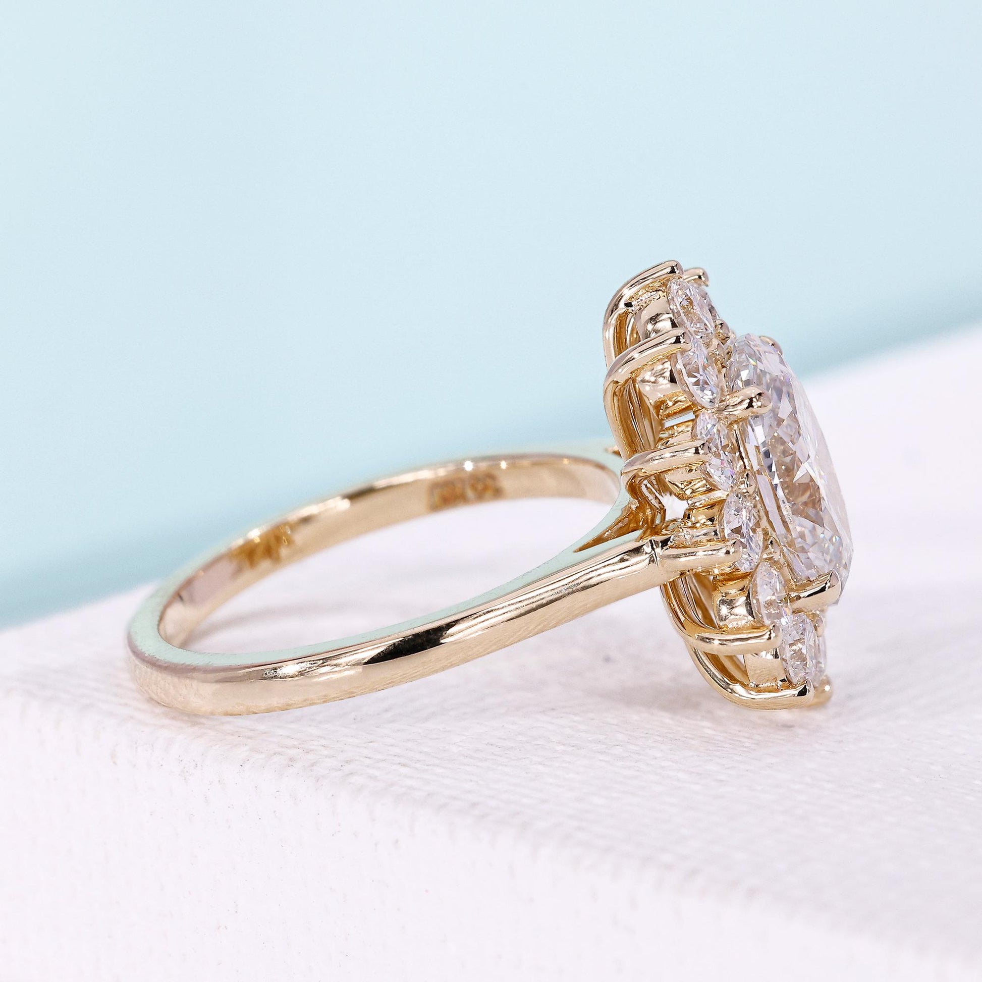 IGI certified oval halo engagement ring in yellow gold