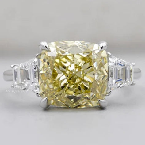 Cushion Cut Fancy Yellow Diamond Three Stone Ring with Tapered Baguette Side Stones