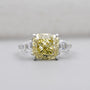 Cushion Cut Fancy Yellow Diamond Three Stone Ring With Tapered Baguette Side Stones IGI Certified