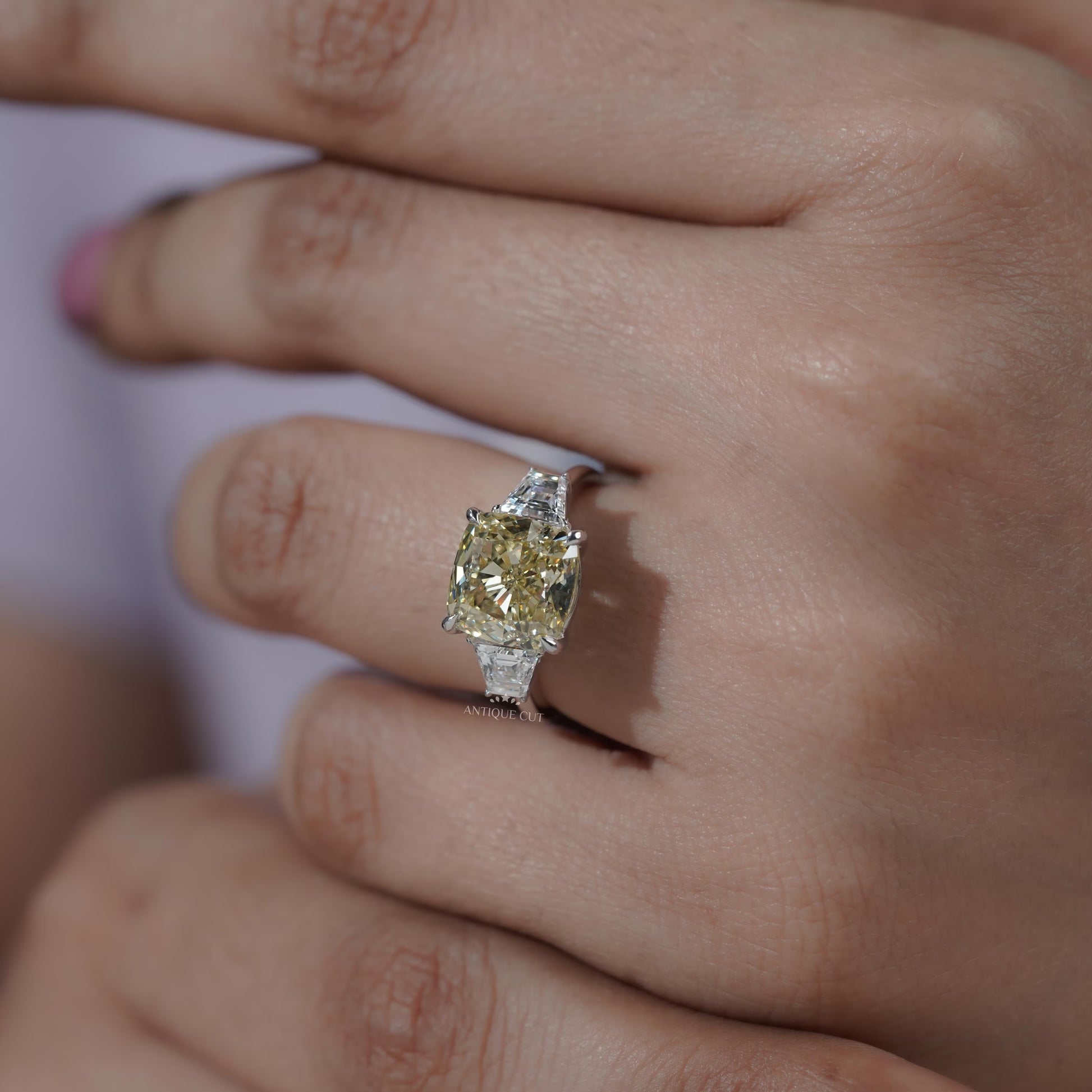 Elegant cushion cut diamond ring with tapered baguette sides