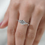 Classic round cut diamond ring with nature inspired setting