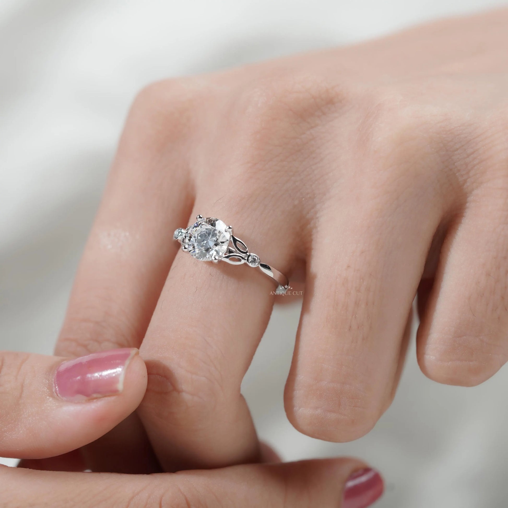 White gold diamond engagement ring with delicate leaf accents
