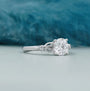 Round cut diamond engagement ring with leaf side accents