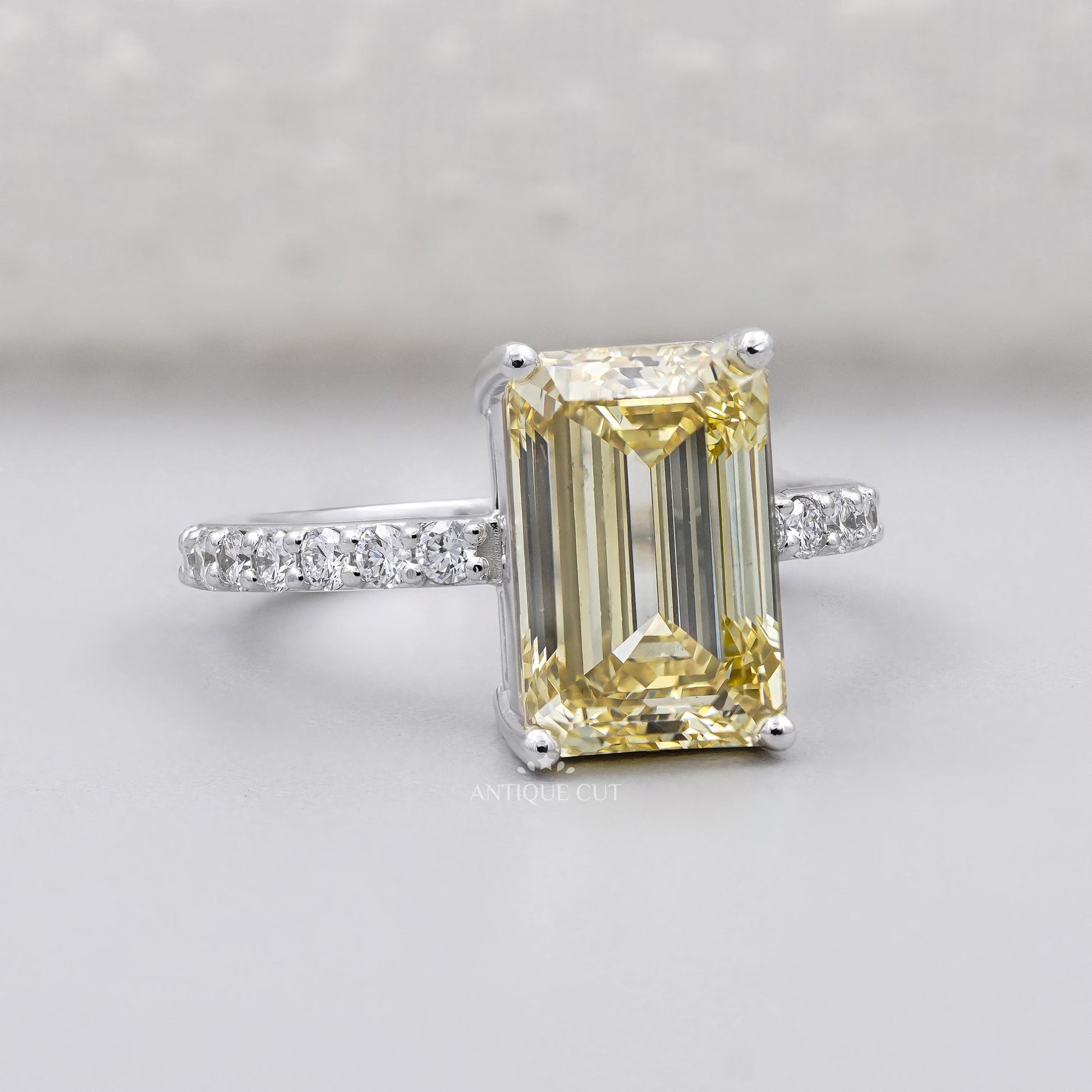 Yellow diamond solitaire engagement ring with round pave band