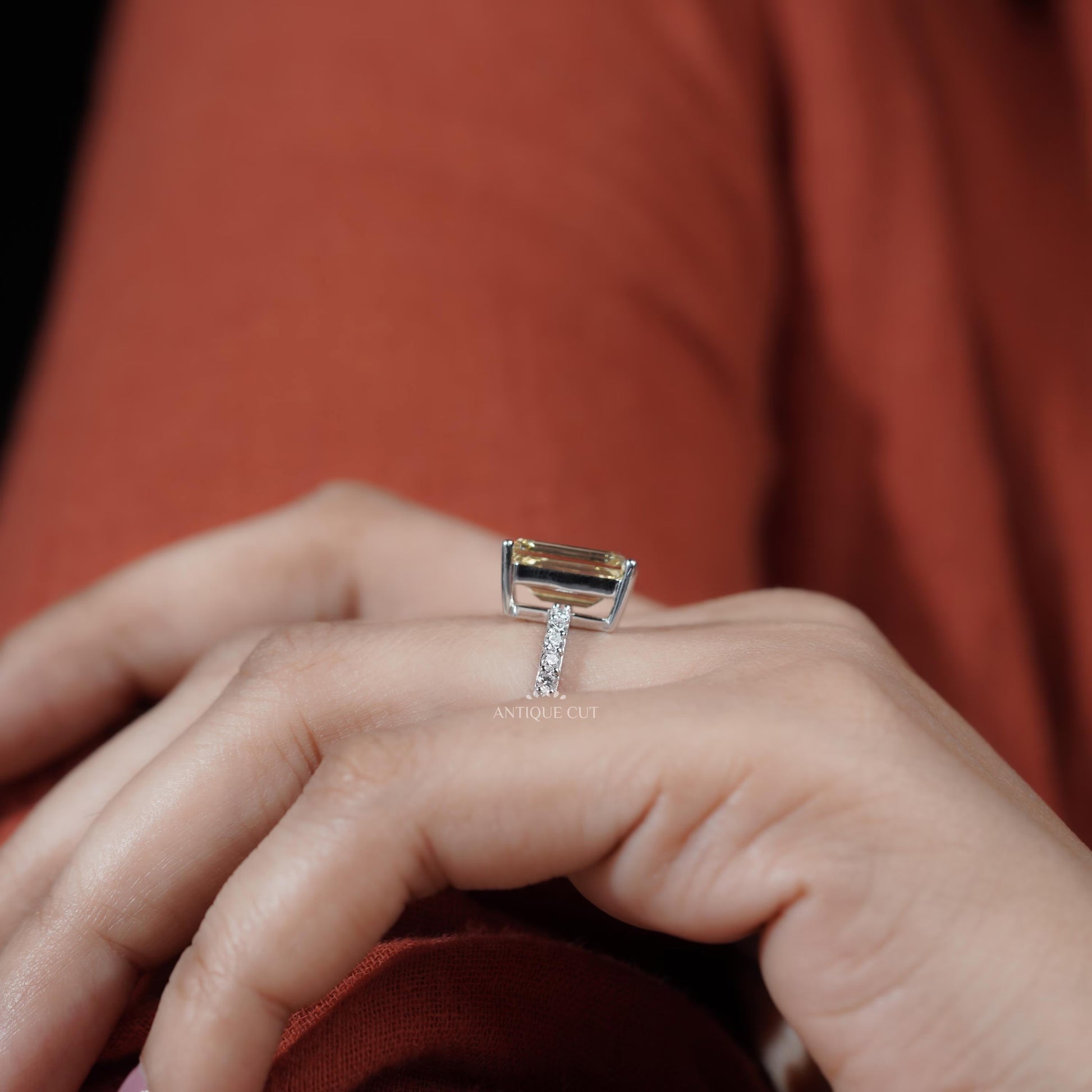 Elegant emerald cut diamond engagement ring with pave band