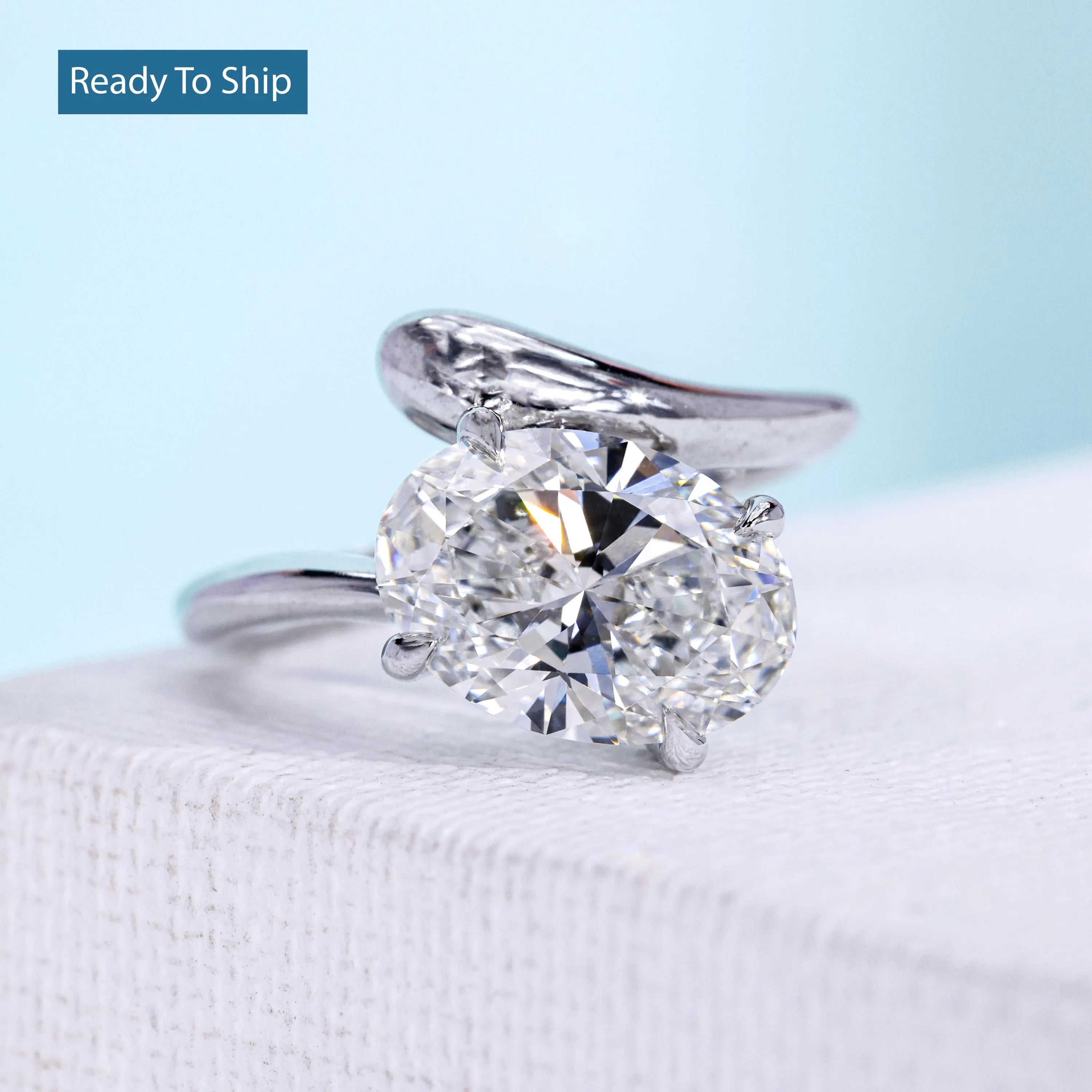 Oval bypass engagement ring with 4 claw prong setting in white gold