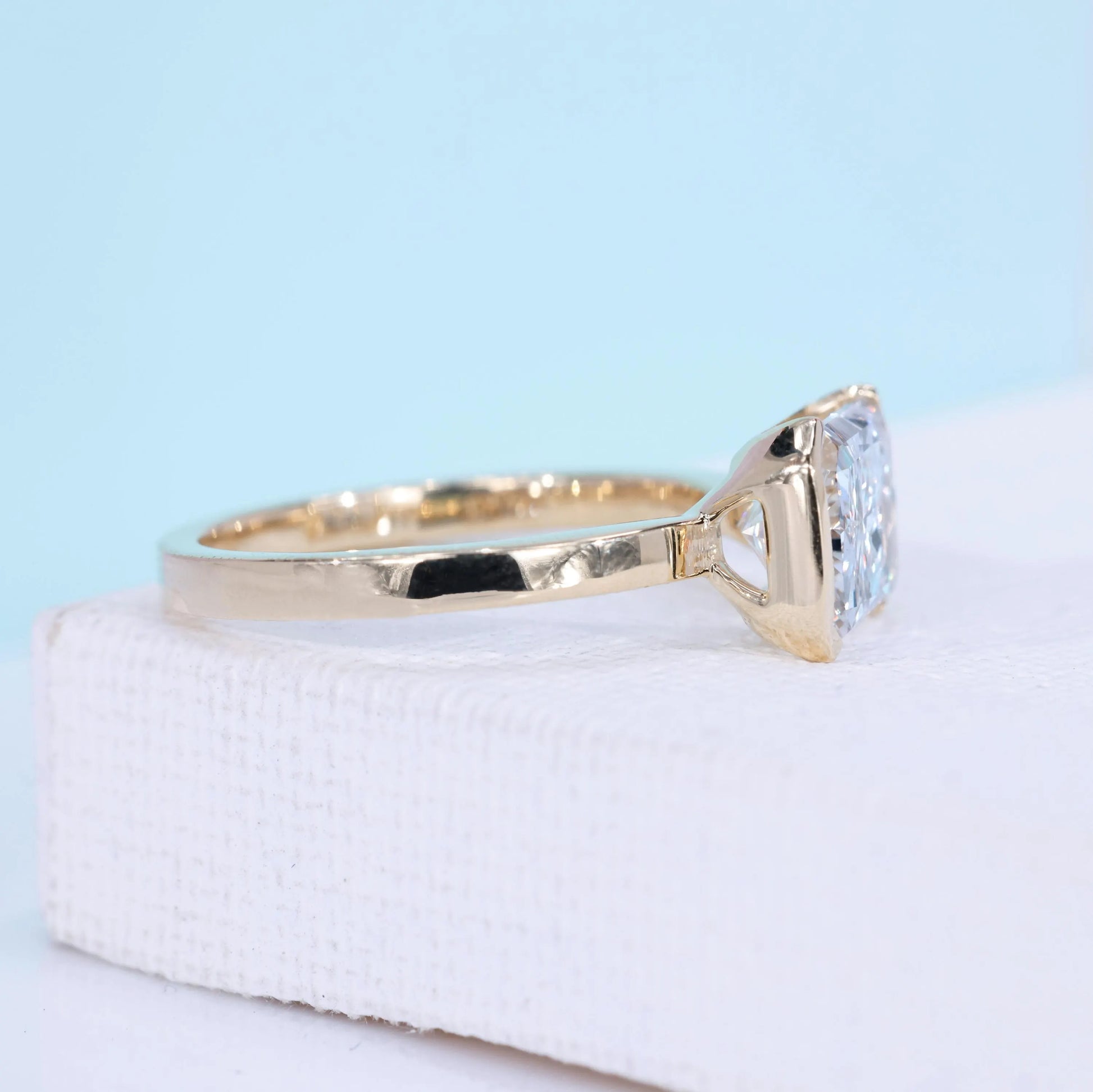 Yellow gold east west engagement ring with radiant cut lab grown diamond