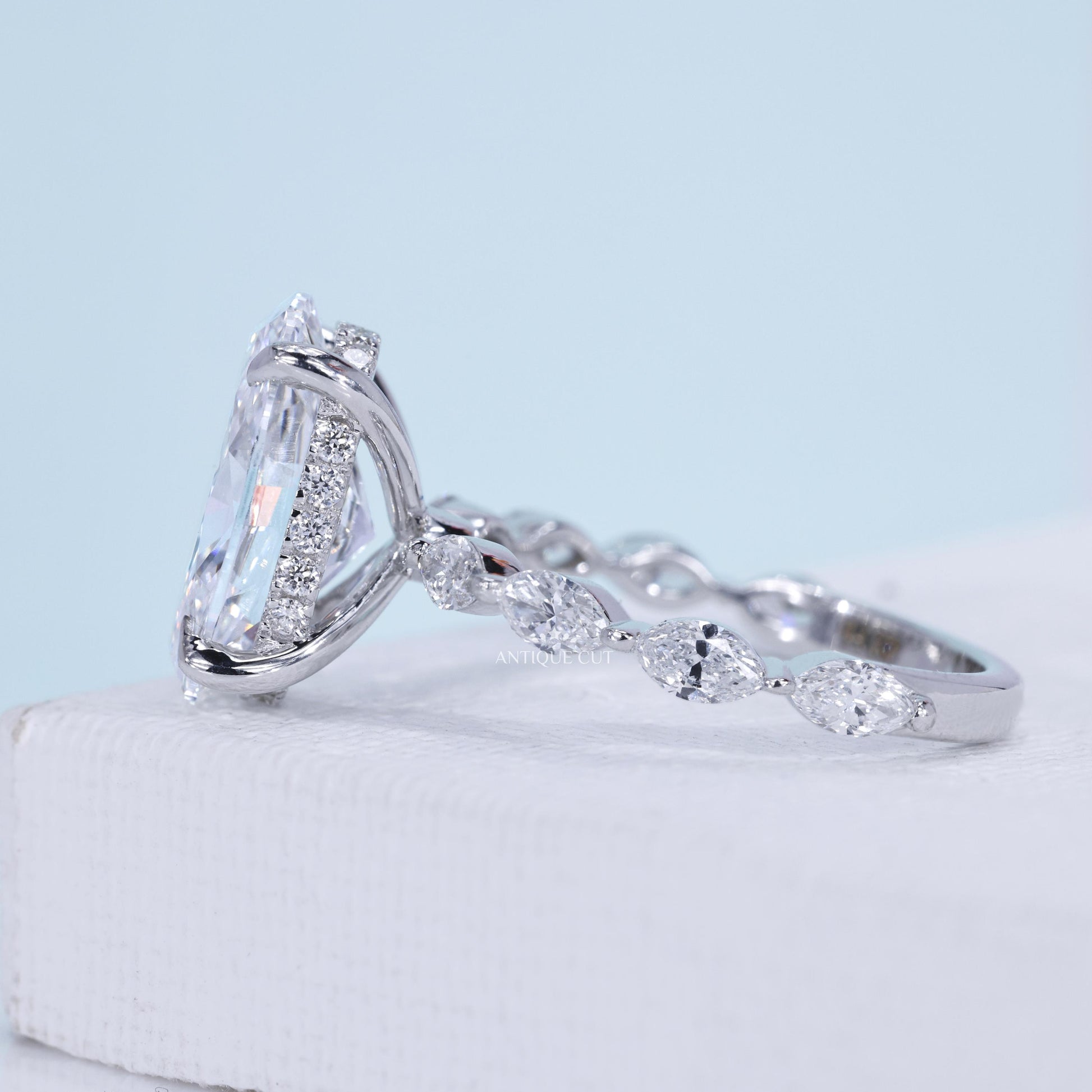 White gold oval diamond ring with marquise side stones and hidden halo setting