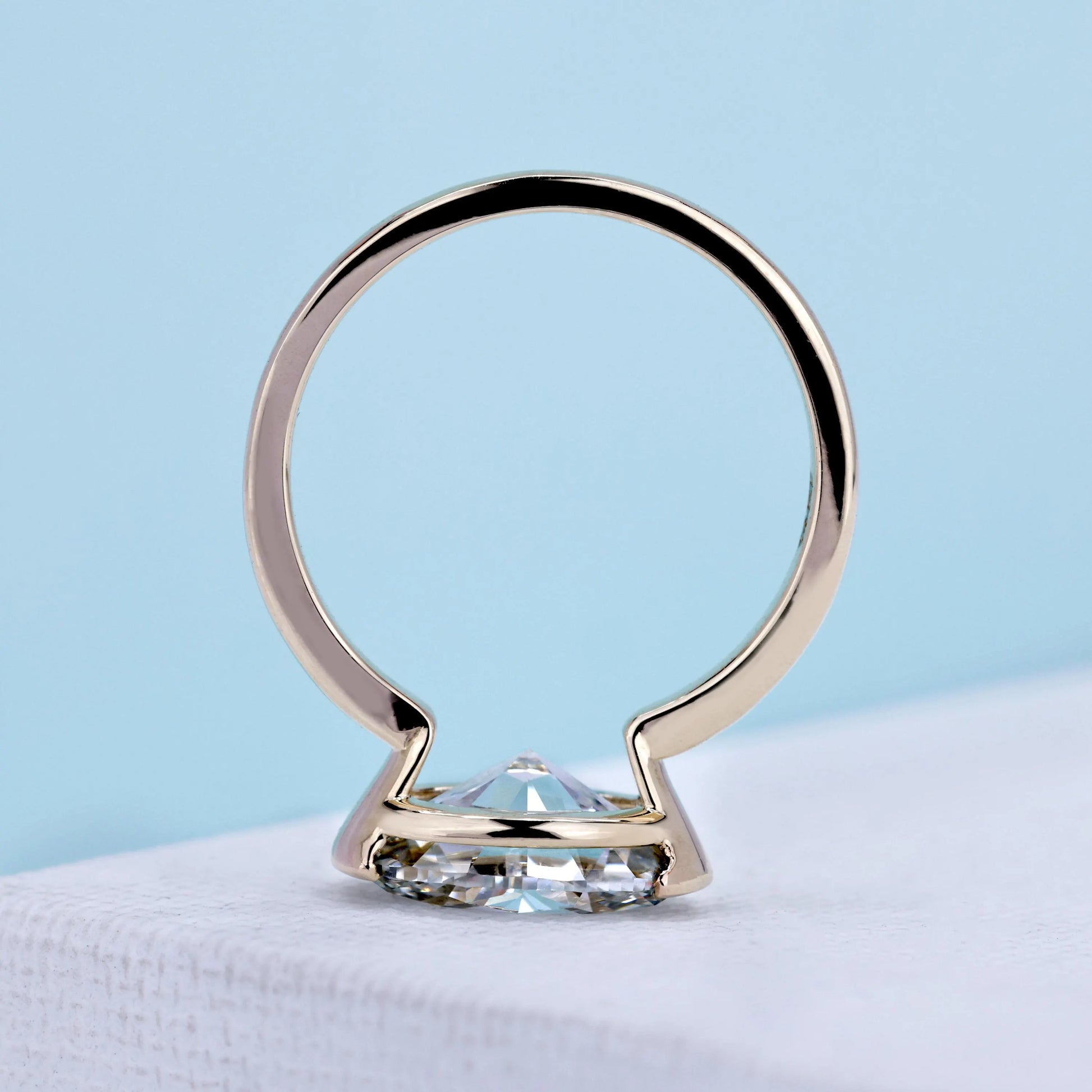 Yellow gold east west solitaire ring with lab grown oval diamond