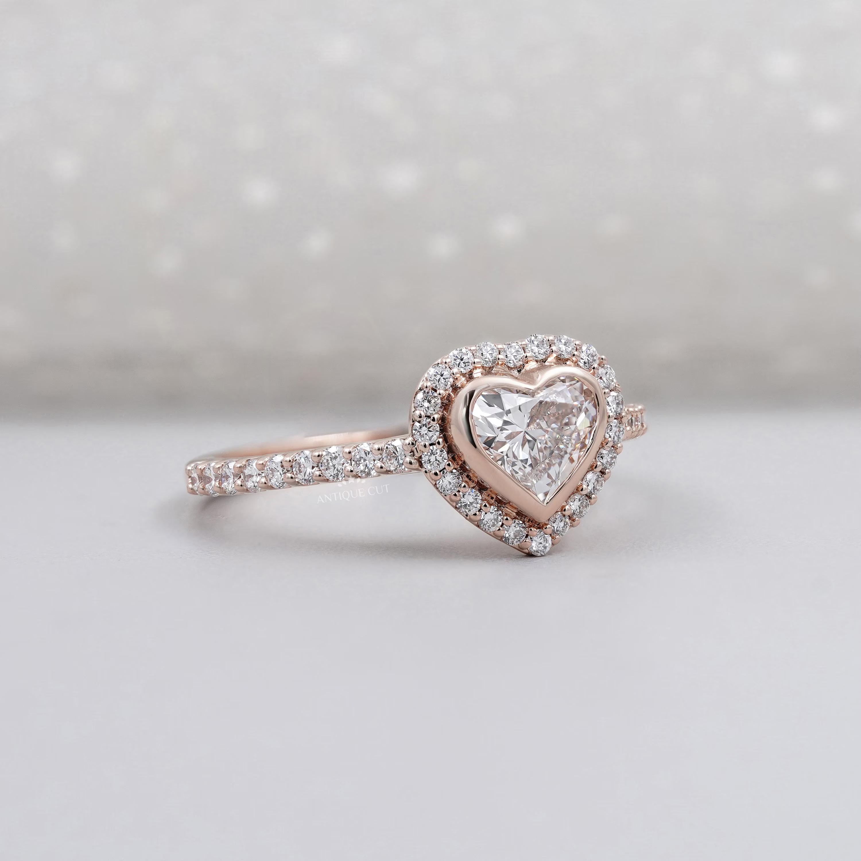 Heart cut diamond engagement ring with bezel halo setting