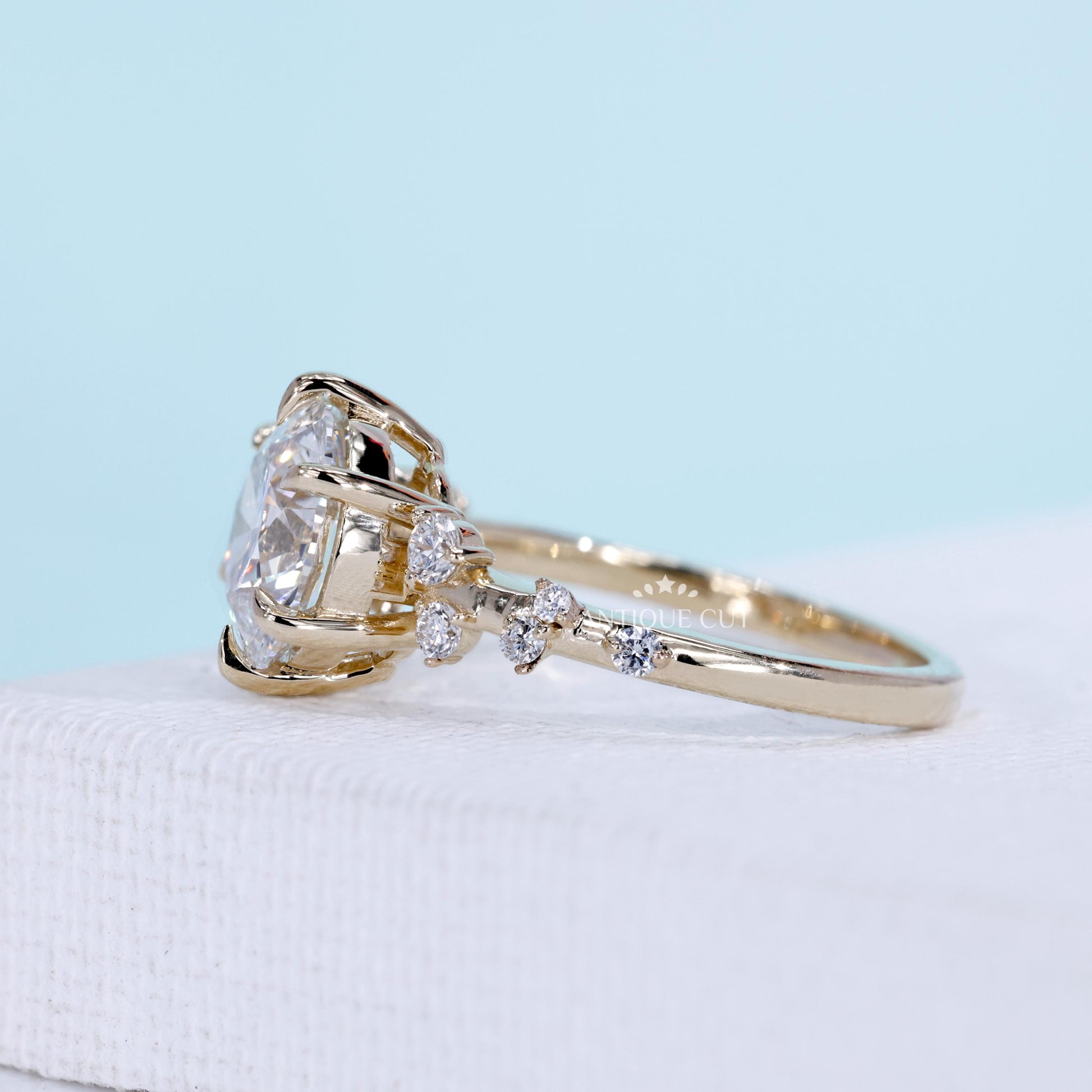 6 prong engagement ring with round cut diamond and side stones