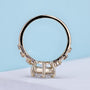 Round diamond engagement ring featuring round cut side stones