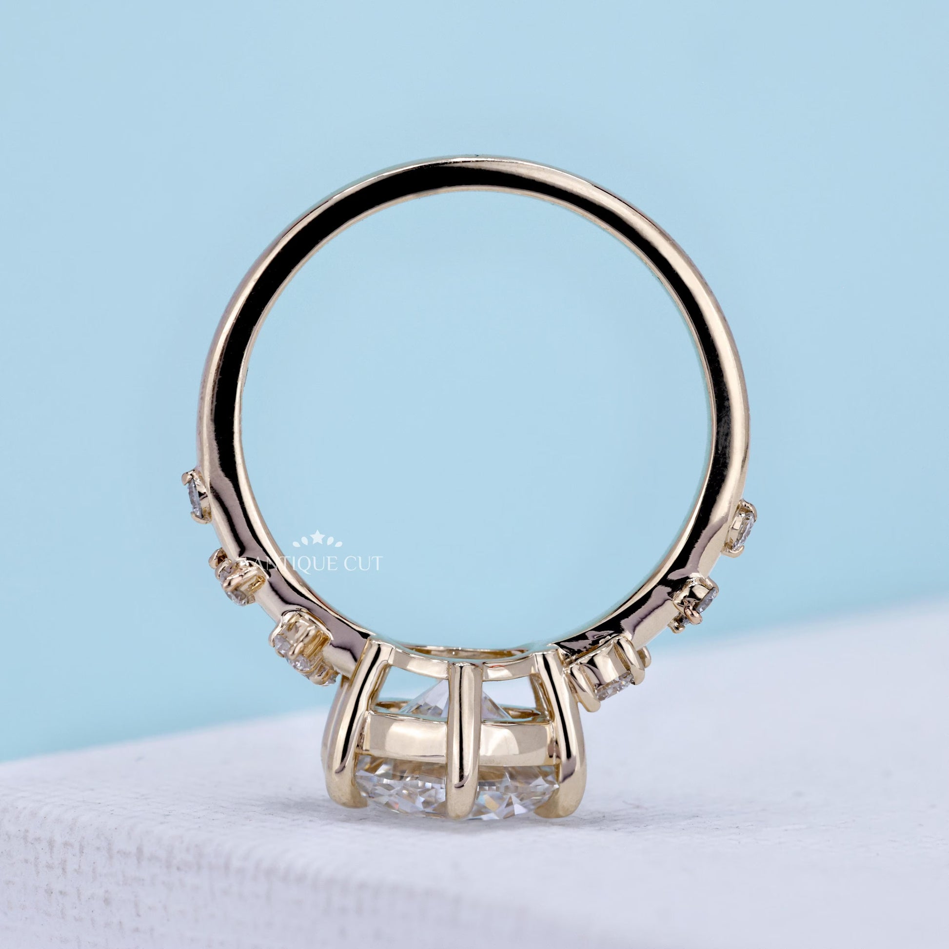 Round diamond engagement ring featuring round cut side stones