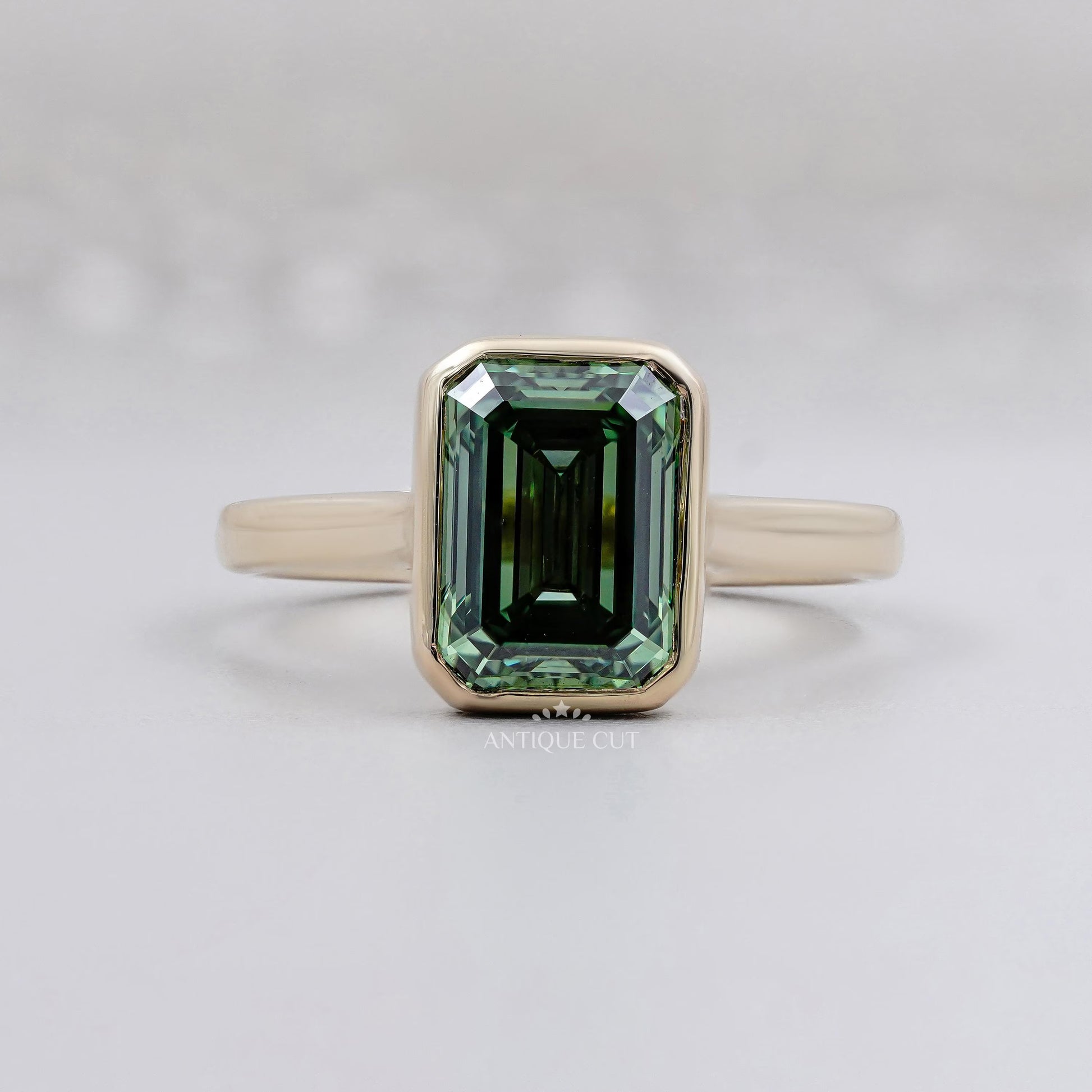 Emerald Cut Green Sapphire Bezel Set Engagement Ring in 14K Yellow Gold