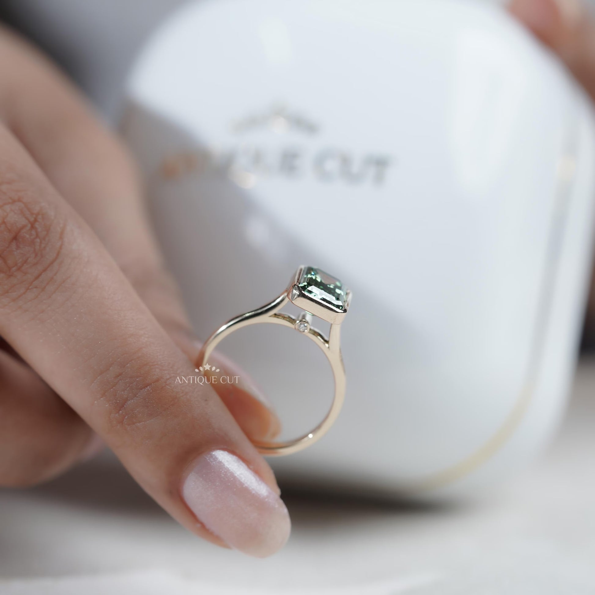 Emerald cut green sapphire proposal ring yellow gold