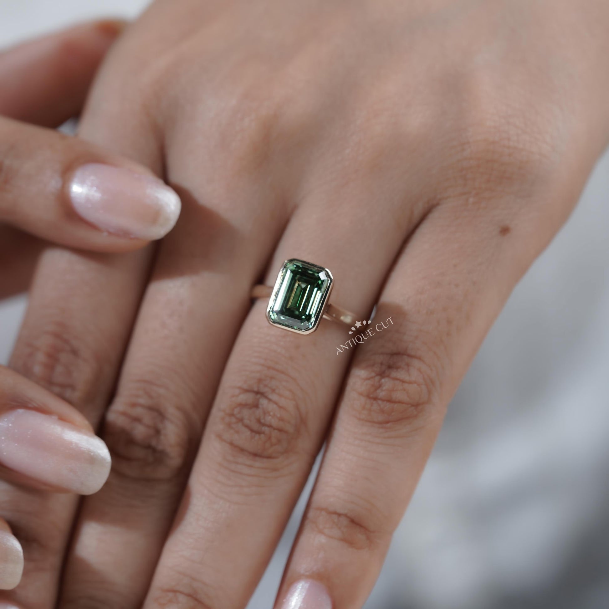 Yellow gold bezel set engagement ring green sapphire