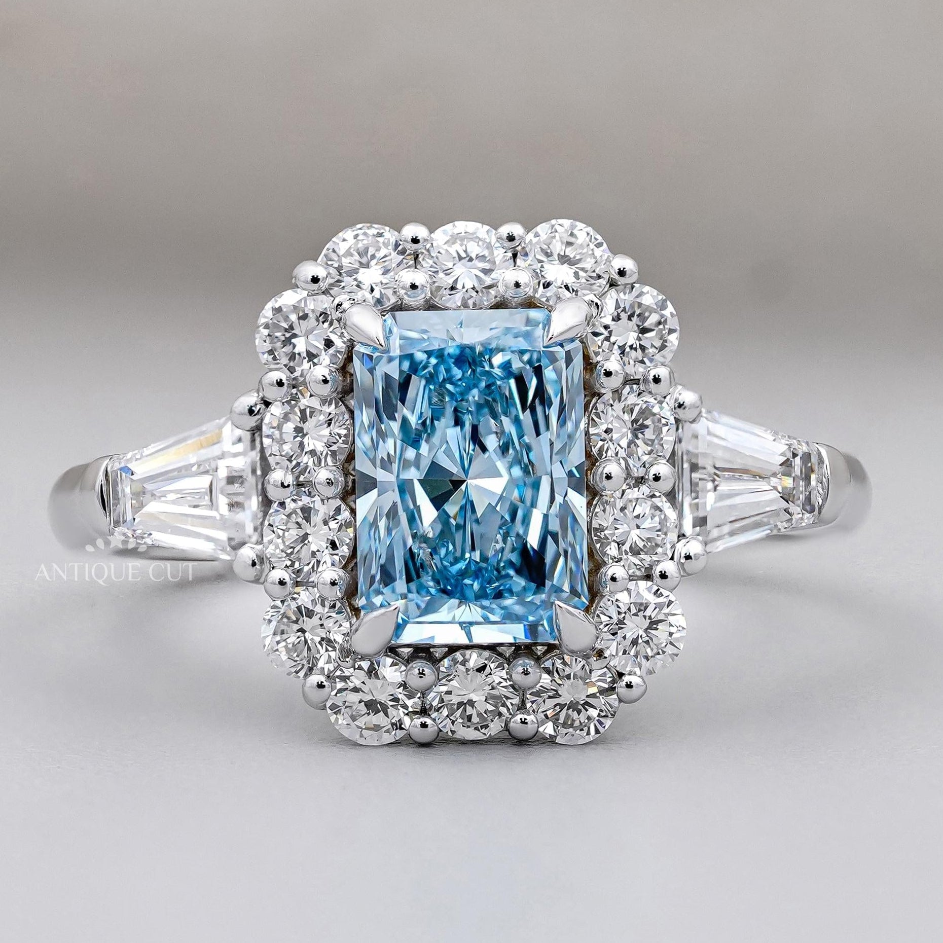 Radiant cut blue topaz halo engagement ring white gold