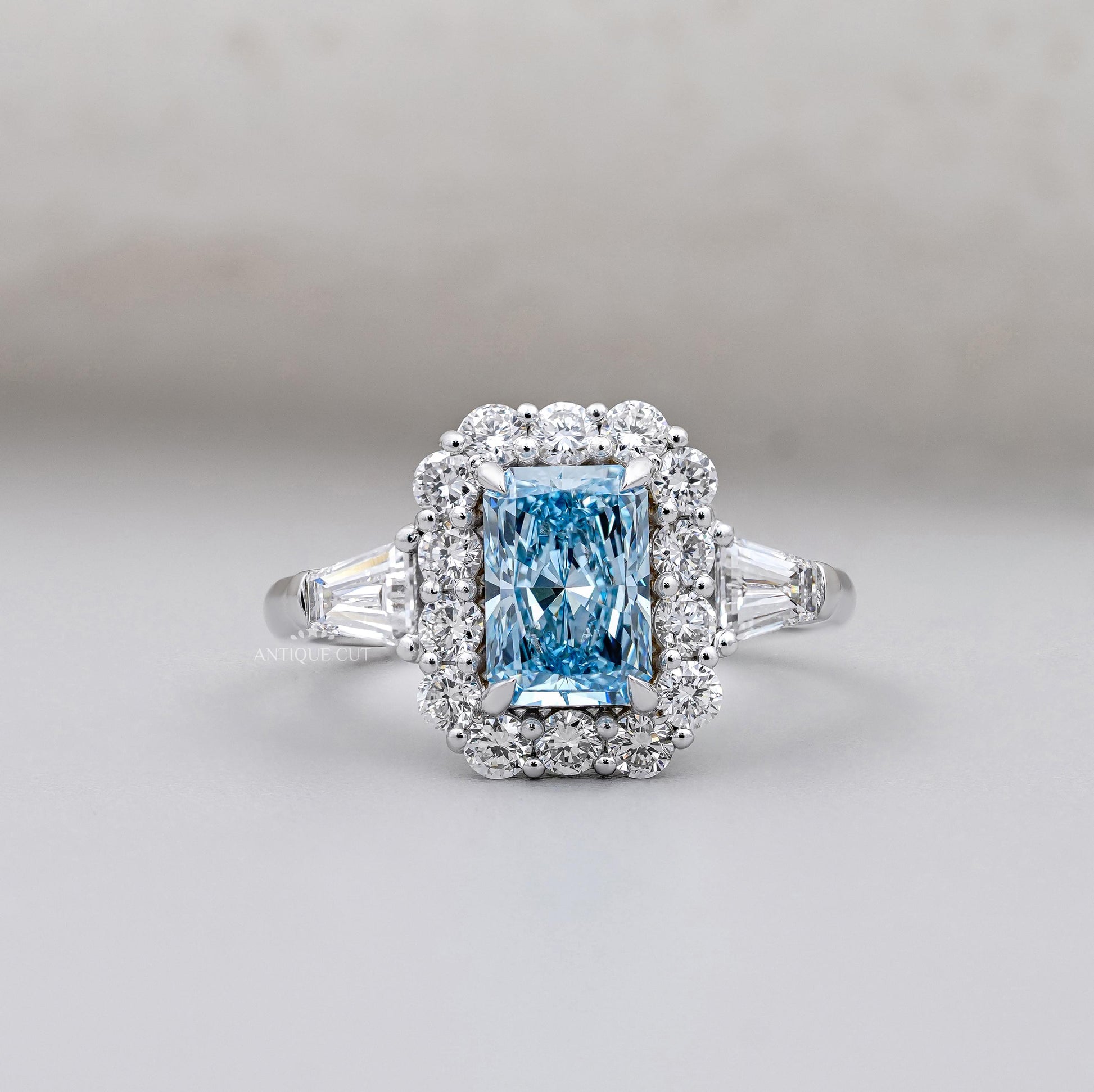 Radiant cut blue topaz halo engagement ring white gold