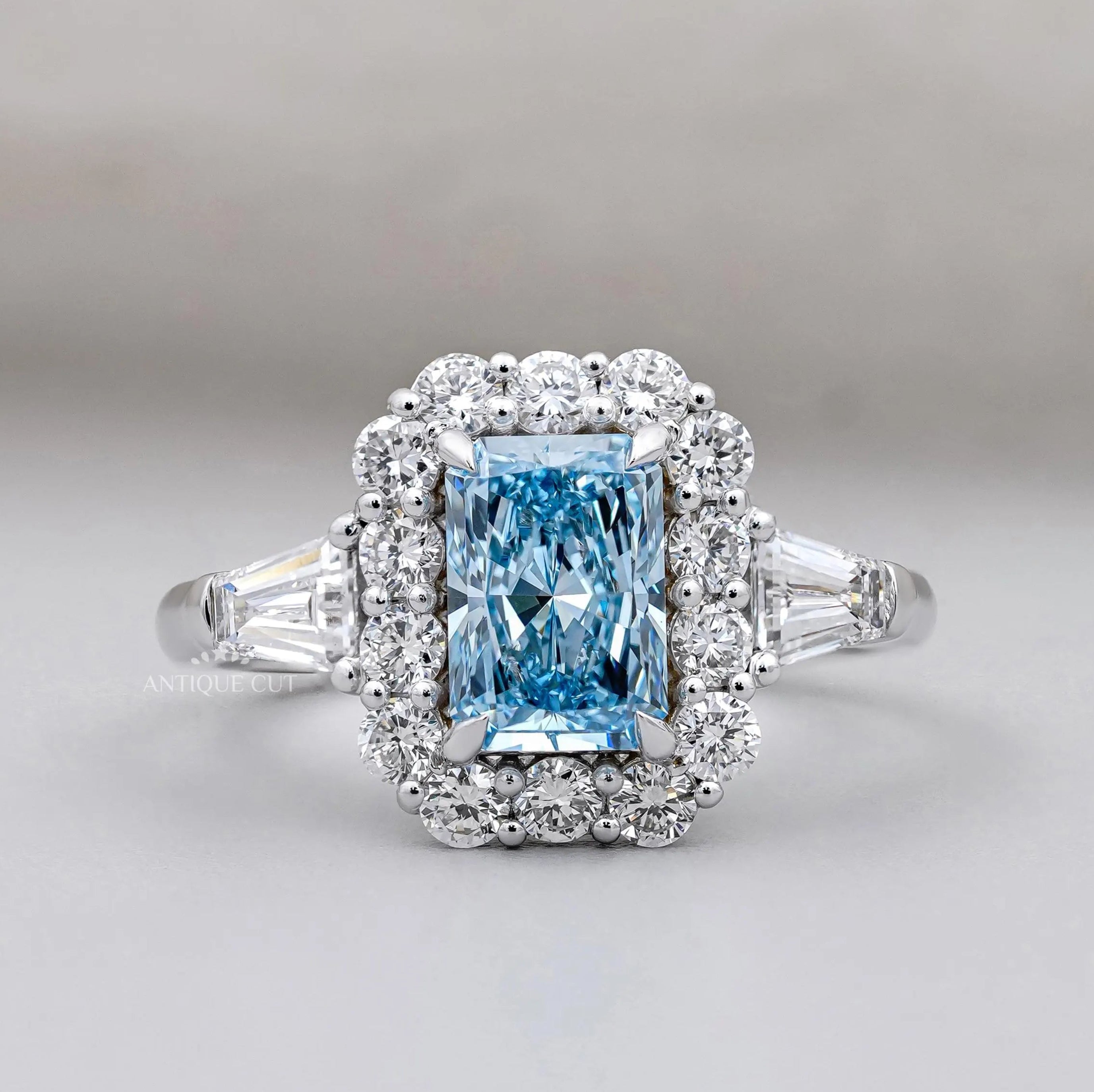 Radiant Cut Blue Topaz Halo Engagement Ring with Tapered Baguette Diamonds