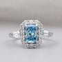 Radiant Cut Blue Topaz Halo Engagement Ring with Tapered Baguette Diamonds