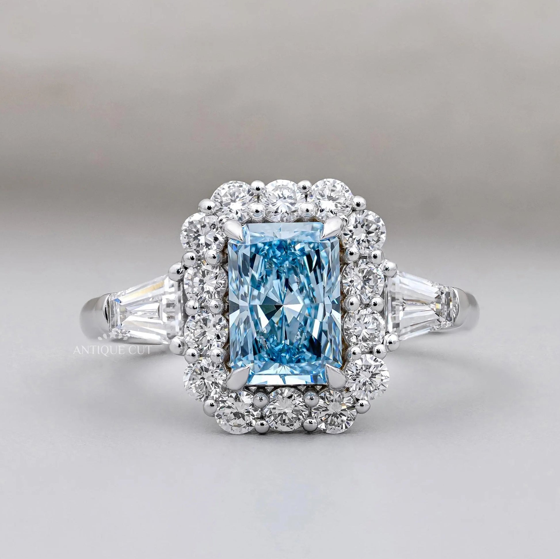 Radiant Cut Blue Topaz Halo Engagement Ring with Tapered Baguette Diamonds