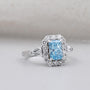 Lab grown blue topaz engagement ring with tapered baguette diamonds