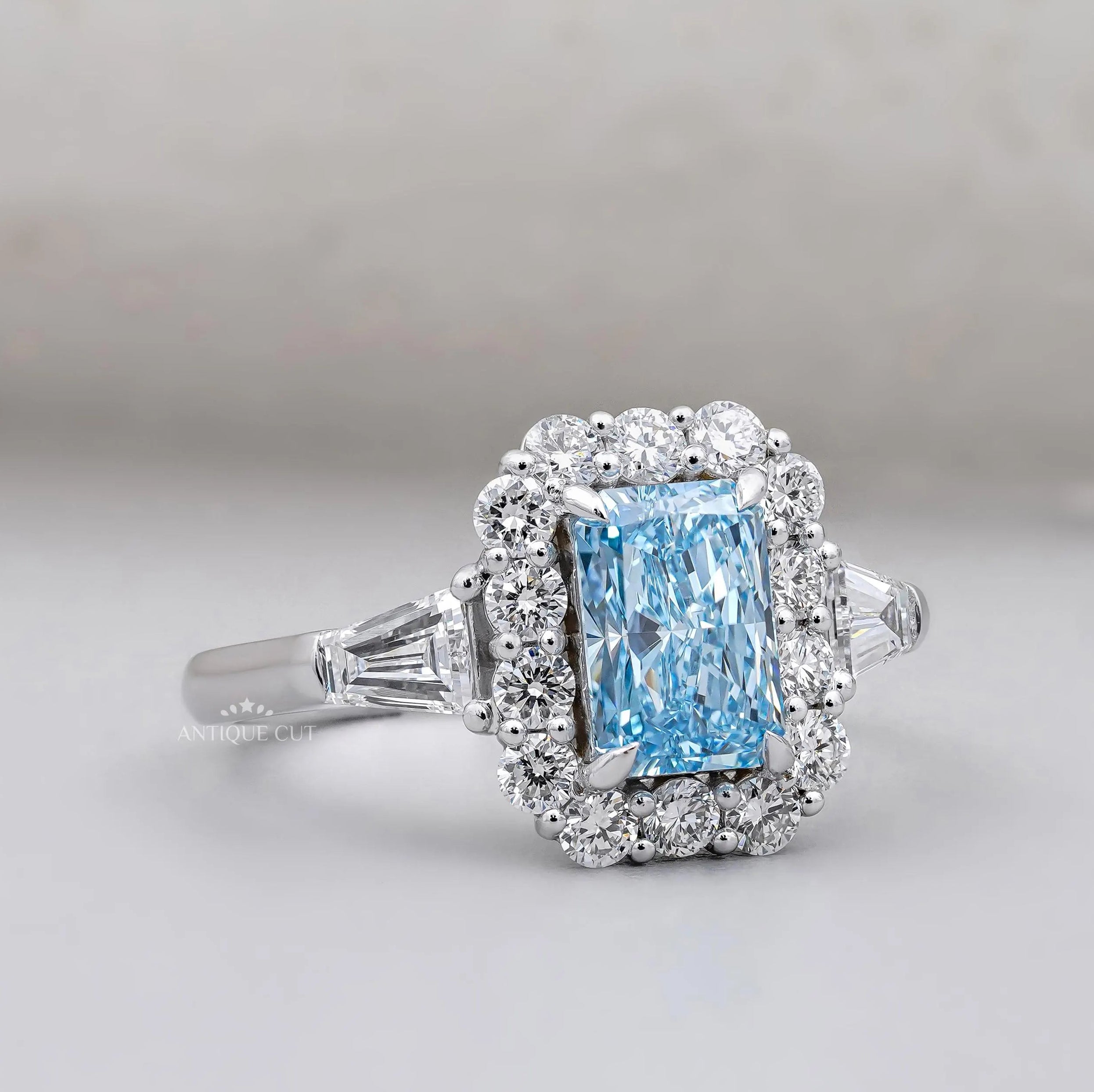 Radiant blue topaz engagement ring with tapered baguette accents