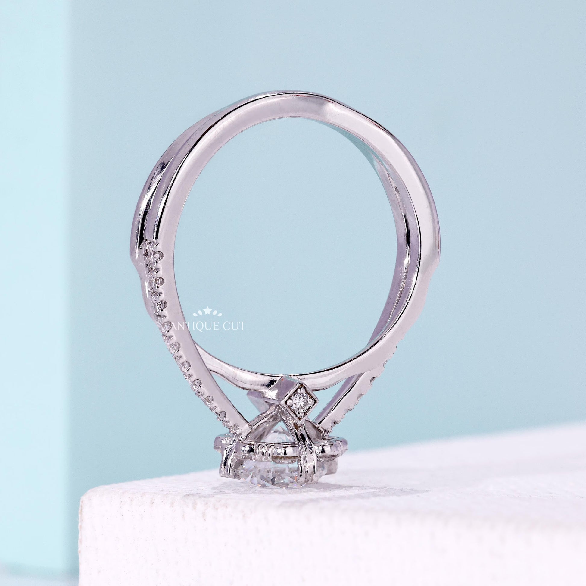 Women’s floral halo ring with twisted band engagement design
