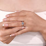 Round cut diamond halo ring featuring pavé twist band detail