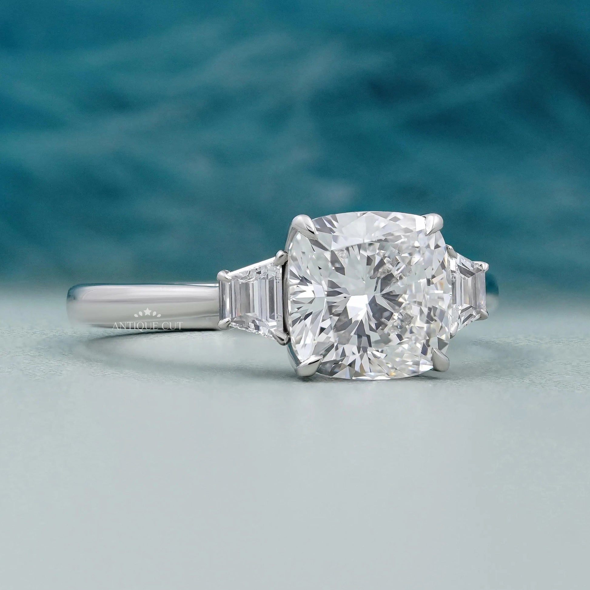 Cushion cut diamond engagement ring with baguette side stones