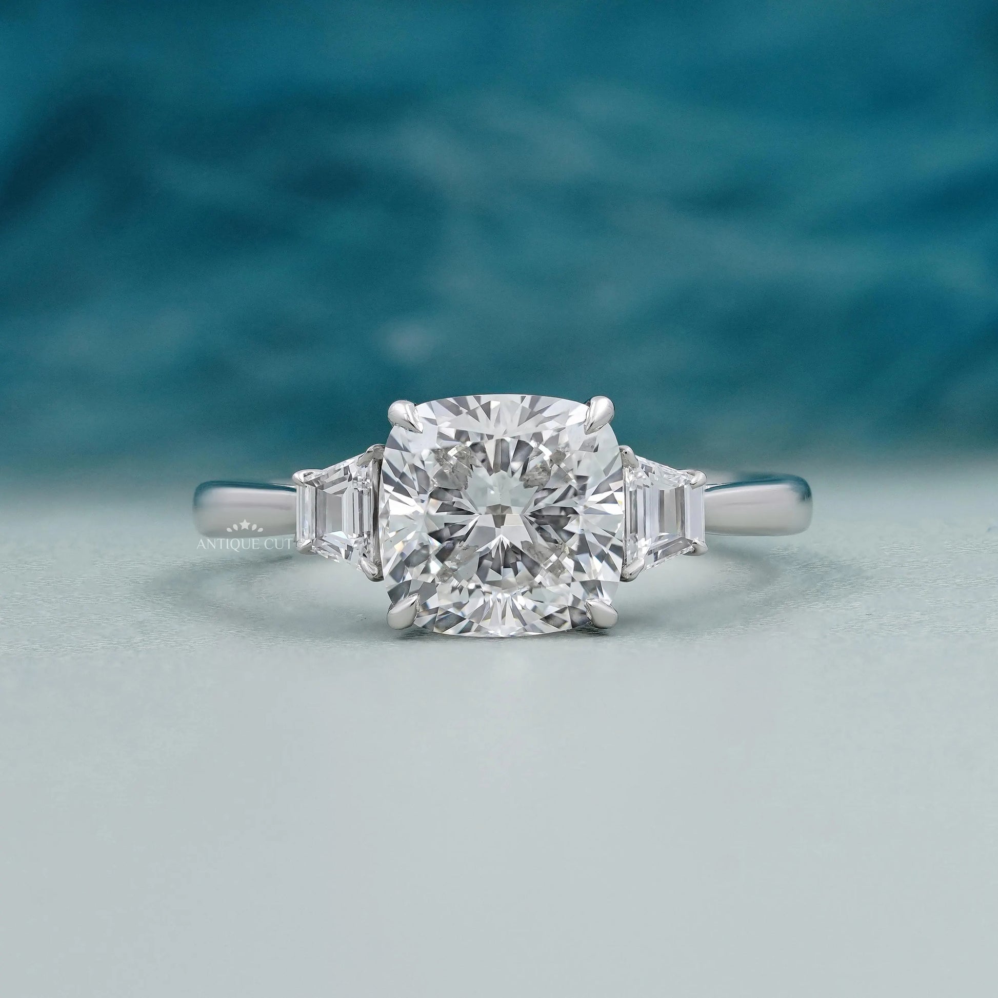 Cushion cut lab grown diamond engagement ring with tapered baguette side stones on white gold.