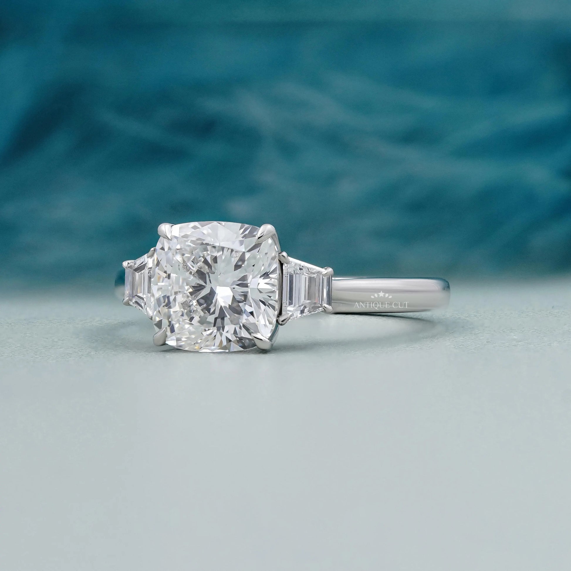 IGI certified cushion cut engagement ring in white gold with tapered baguette accents.